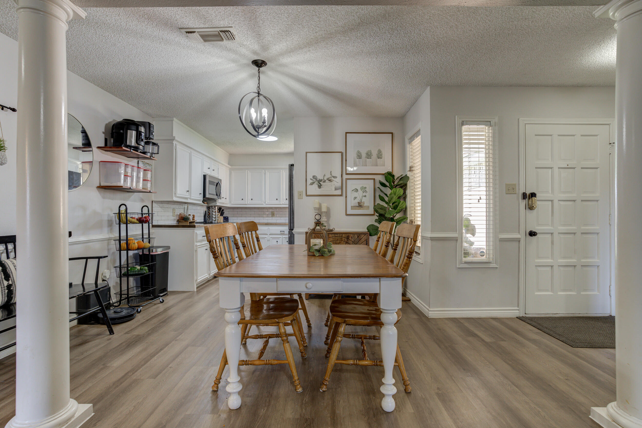 3712 103rd Street Lubbock, TX 79423 - Photo 12 of 43 a view of a dining room with furniture and wooden floor