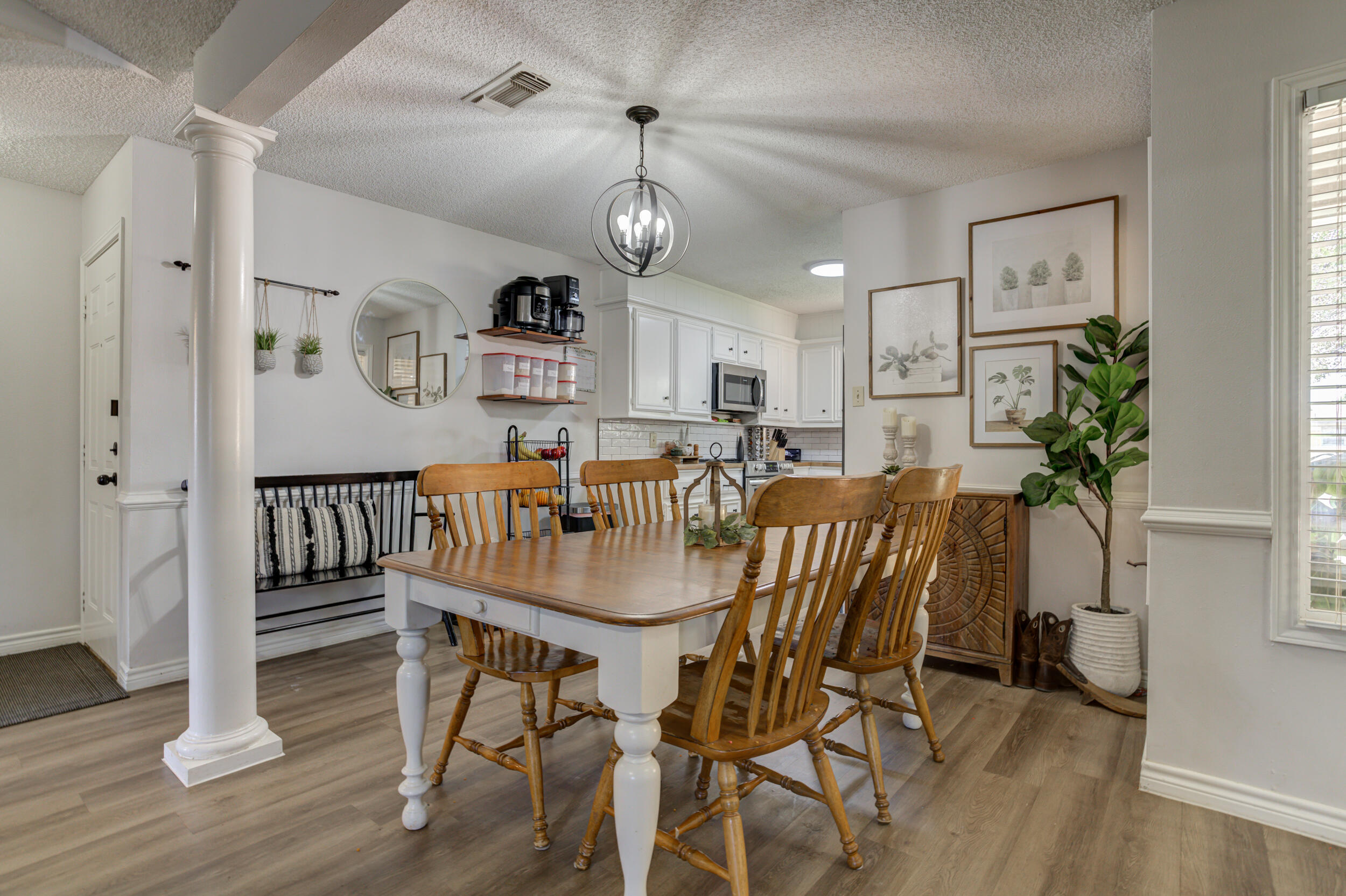 3712 103rd Street Lubbock, TX 79423 - Photo 13 of 43 a view of a dining room with furniture and wooden floor