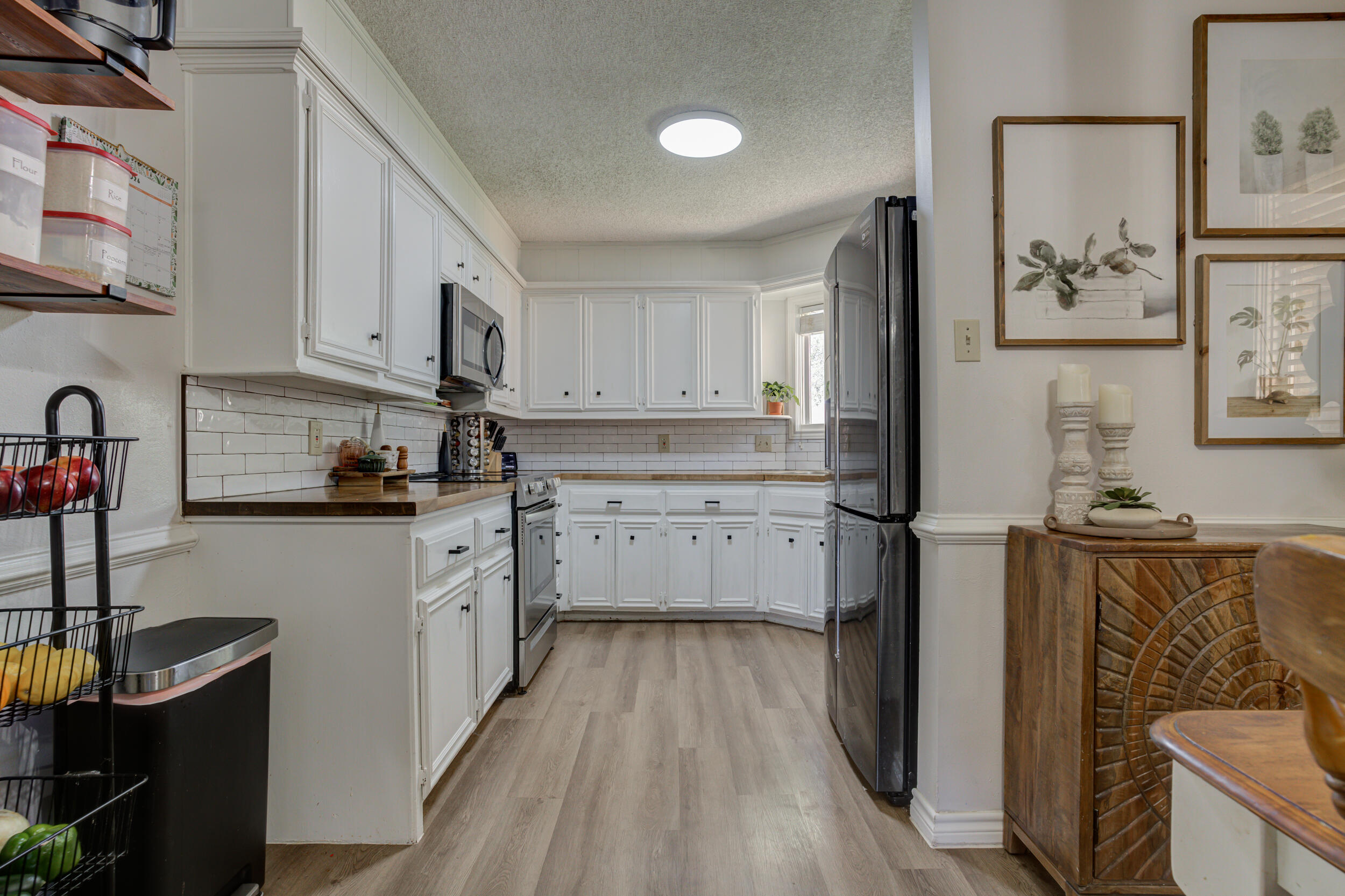 3712 103rd Street Lubbock, TX 79423 - Photo 14 of 43 a kitchen with stainless steel appliances granite countertop a stove a sink and a refrigerator