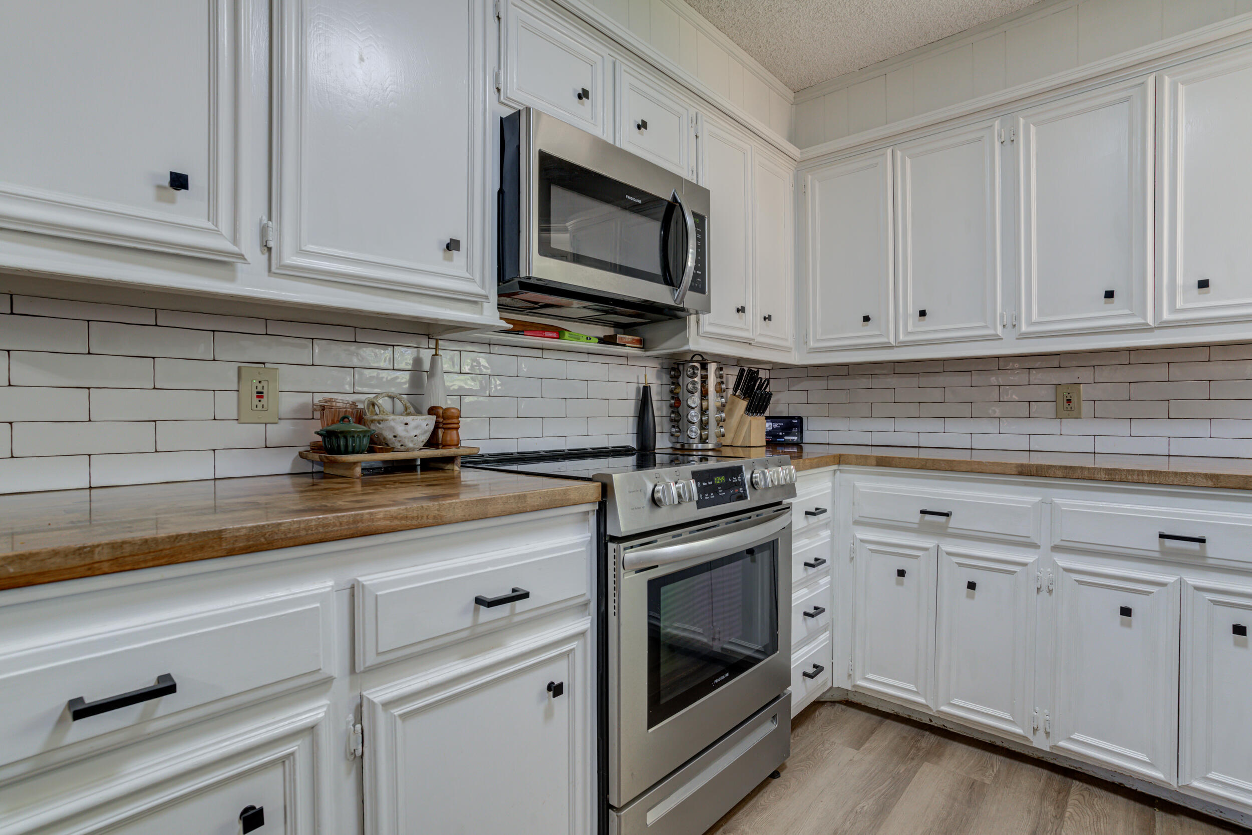 3712 103rd Street Lubbock, TX 79423 - Photo 17 of 43 a kitchen with white cabinets and white appliances