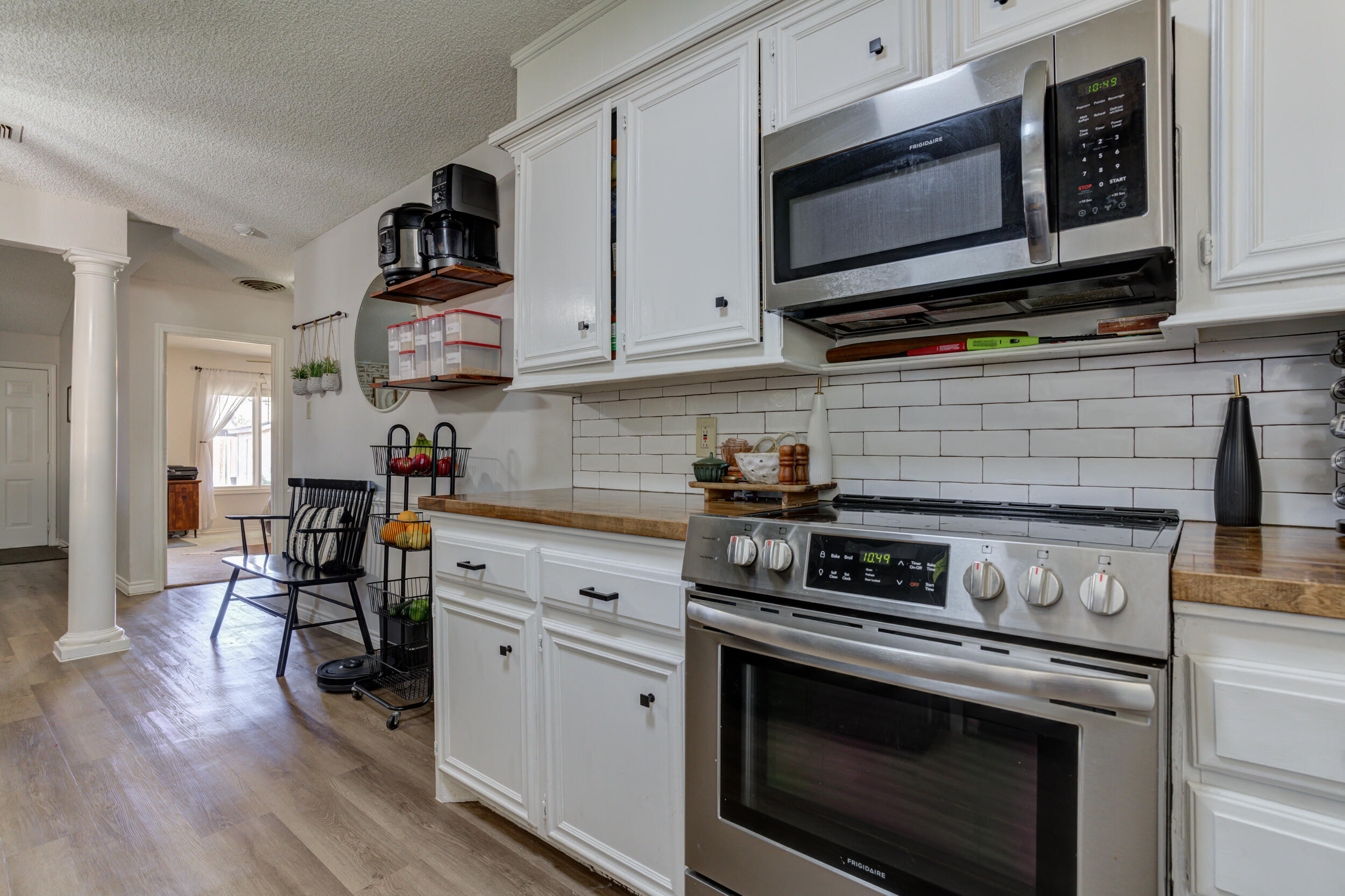 3712 103rd Street Lubbock, TX 79423 - Photo 18 of 43 a kitchen with stainless steel appliances a stove microwave and cabinets