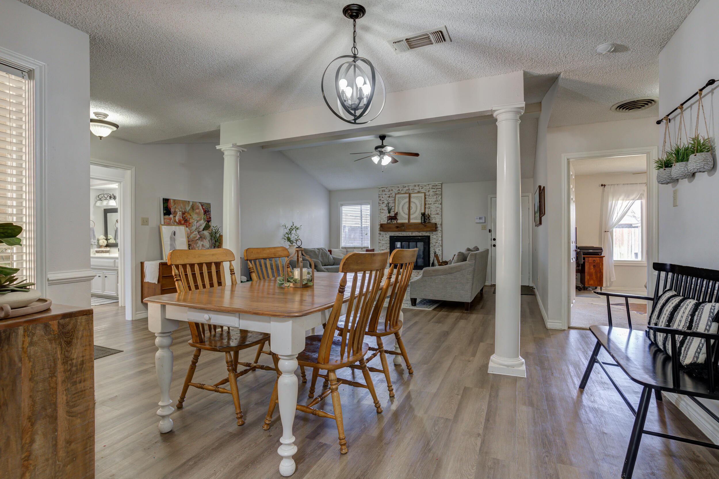 3712 103rd Street Lubbock, TX 79423 - Photo 20 of 43 a dining room with furniture a chandelier and wooden floor