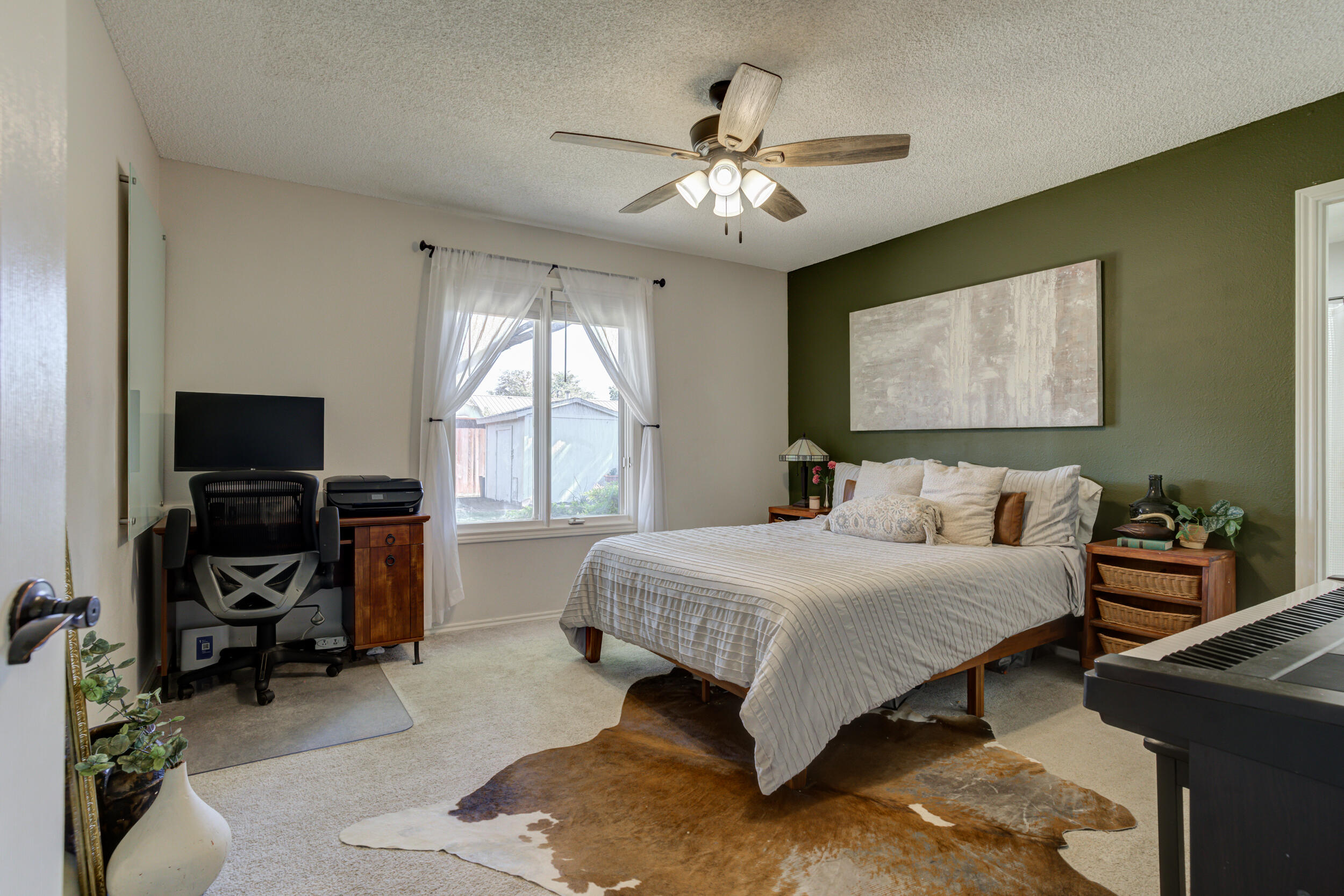 3712 103rd Street Lubbock, TX 79423 - Photo 27 of 43 a bedroom with a bed and a chandelier