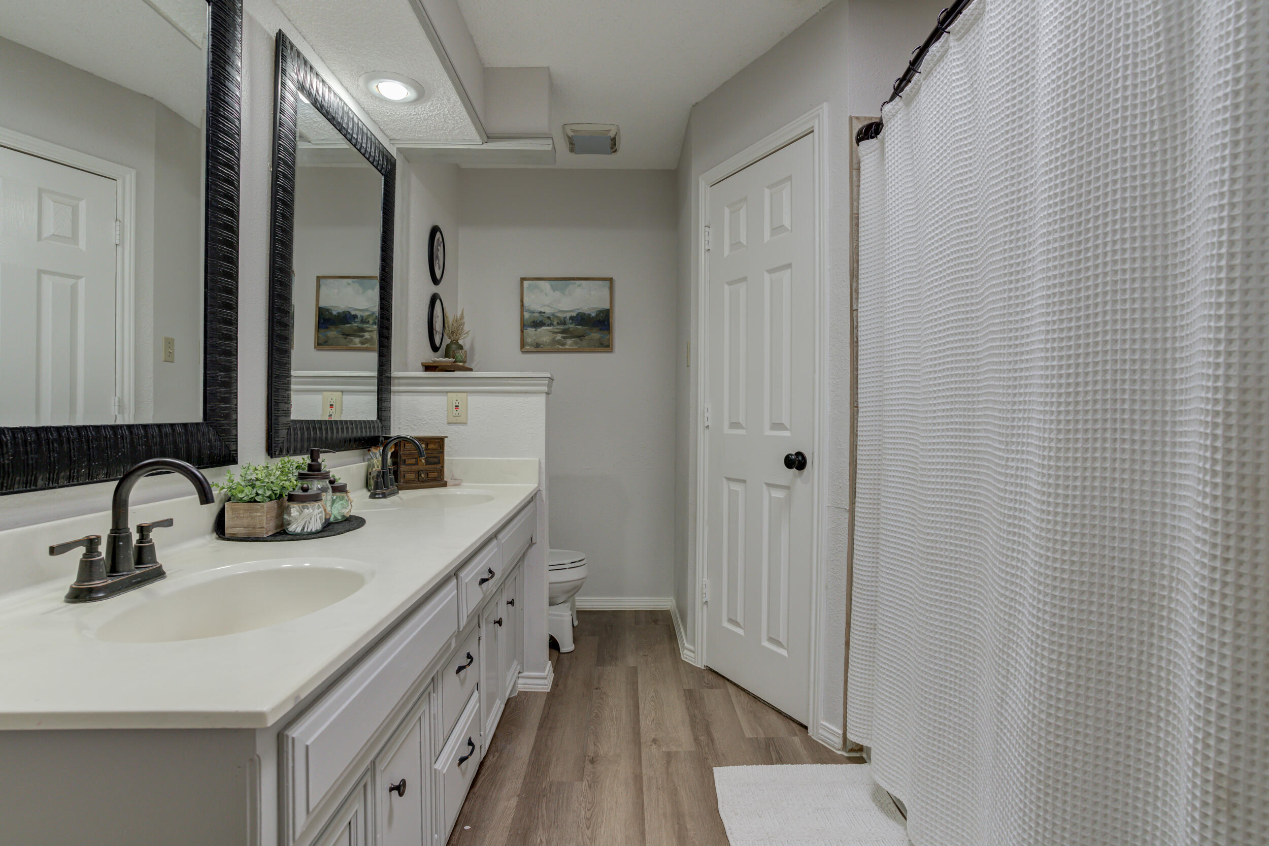 3712 103rd Street Lubbock, TX 79423 - Photo 30 of 43 a bathroom with 2 sink and a mirror