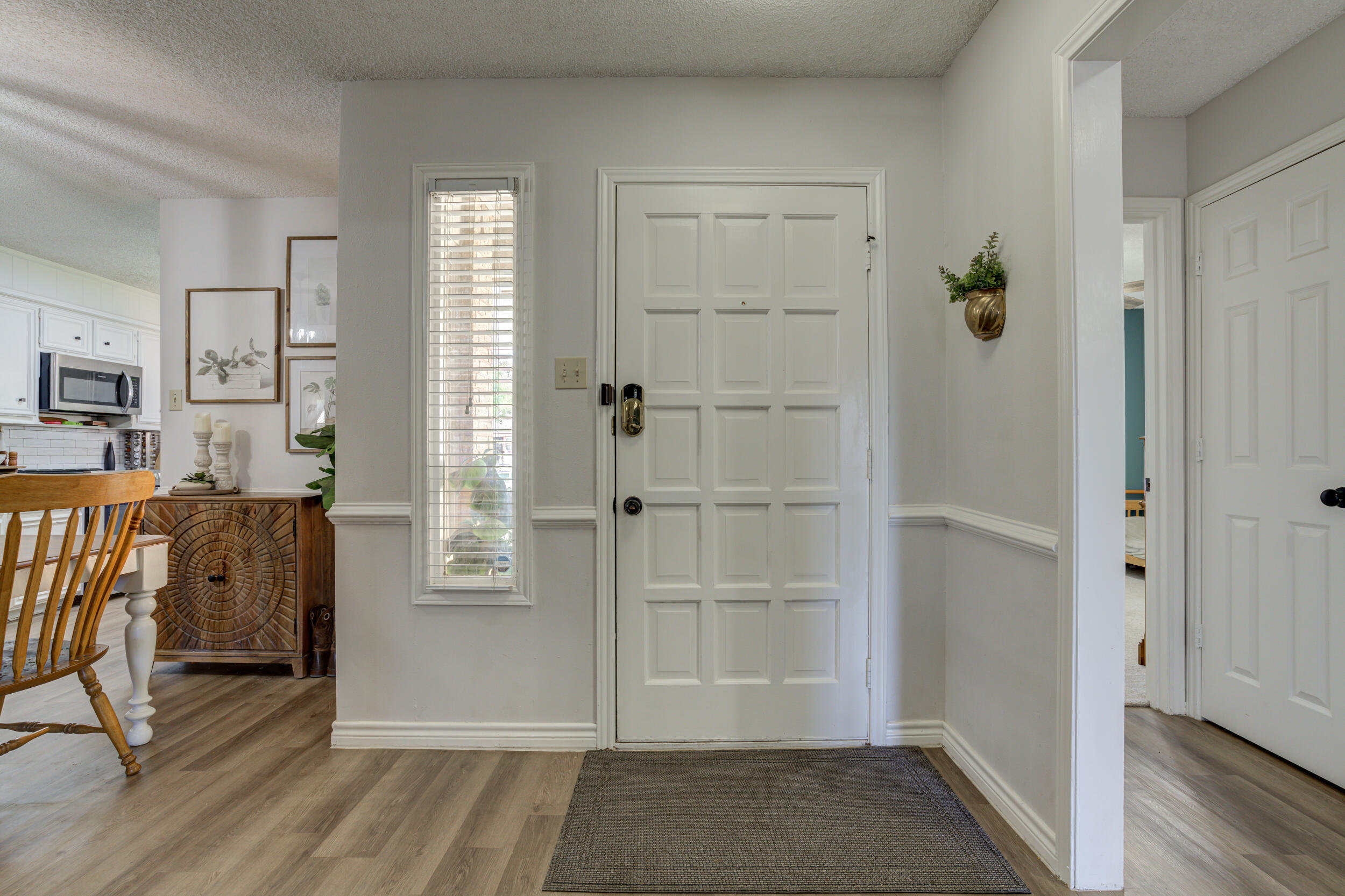 3712 103rd Street Lubbock, TX 79423 - Photo 3 of 43 a view of a hallway with wooden floor and closet area