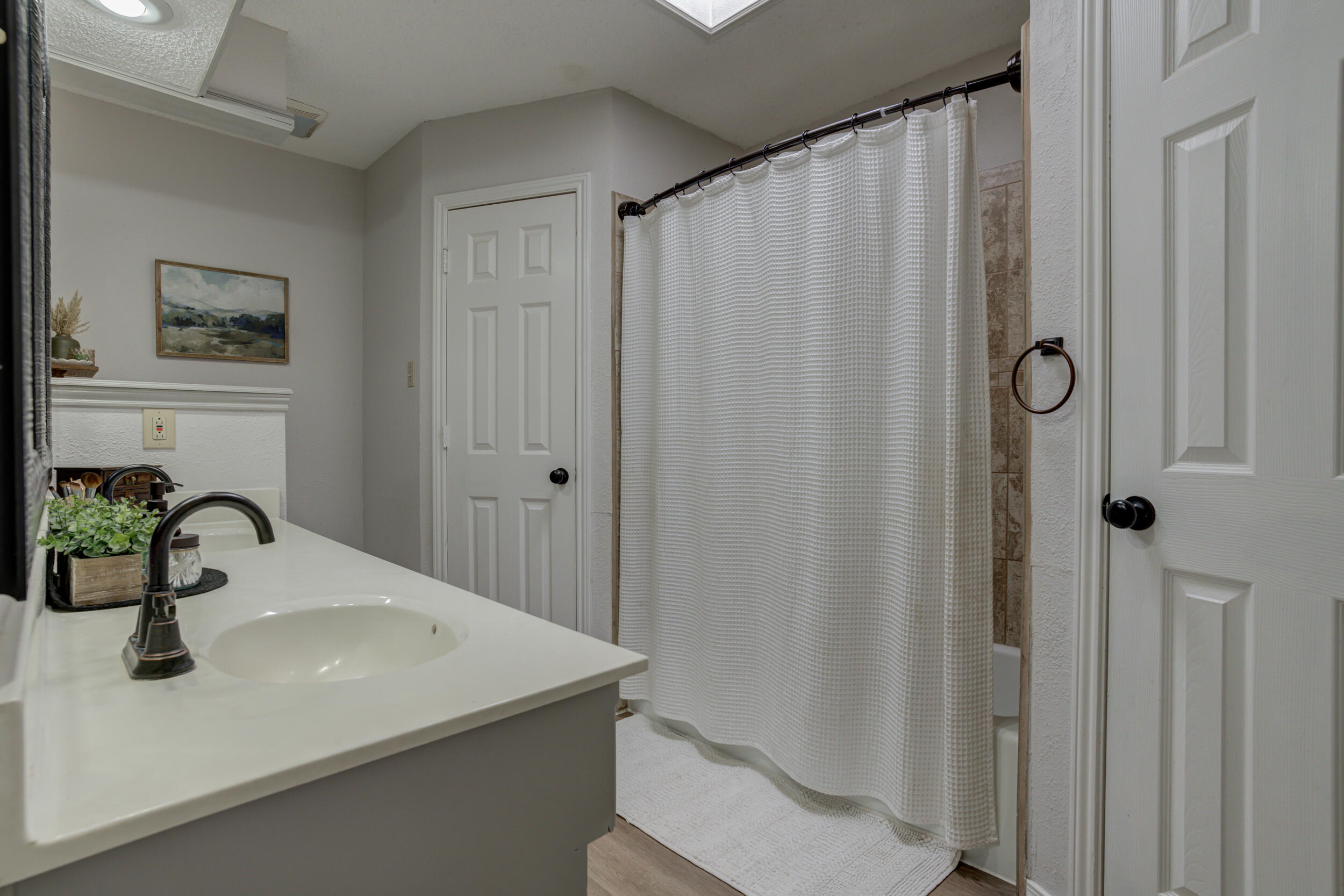 3712 103rd Street Lubbock, TX 79423 - Photo 31 of 43 a bathroom with a sink and a mirror
