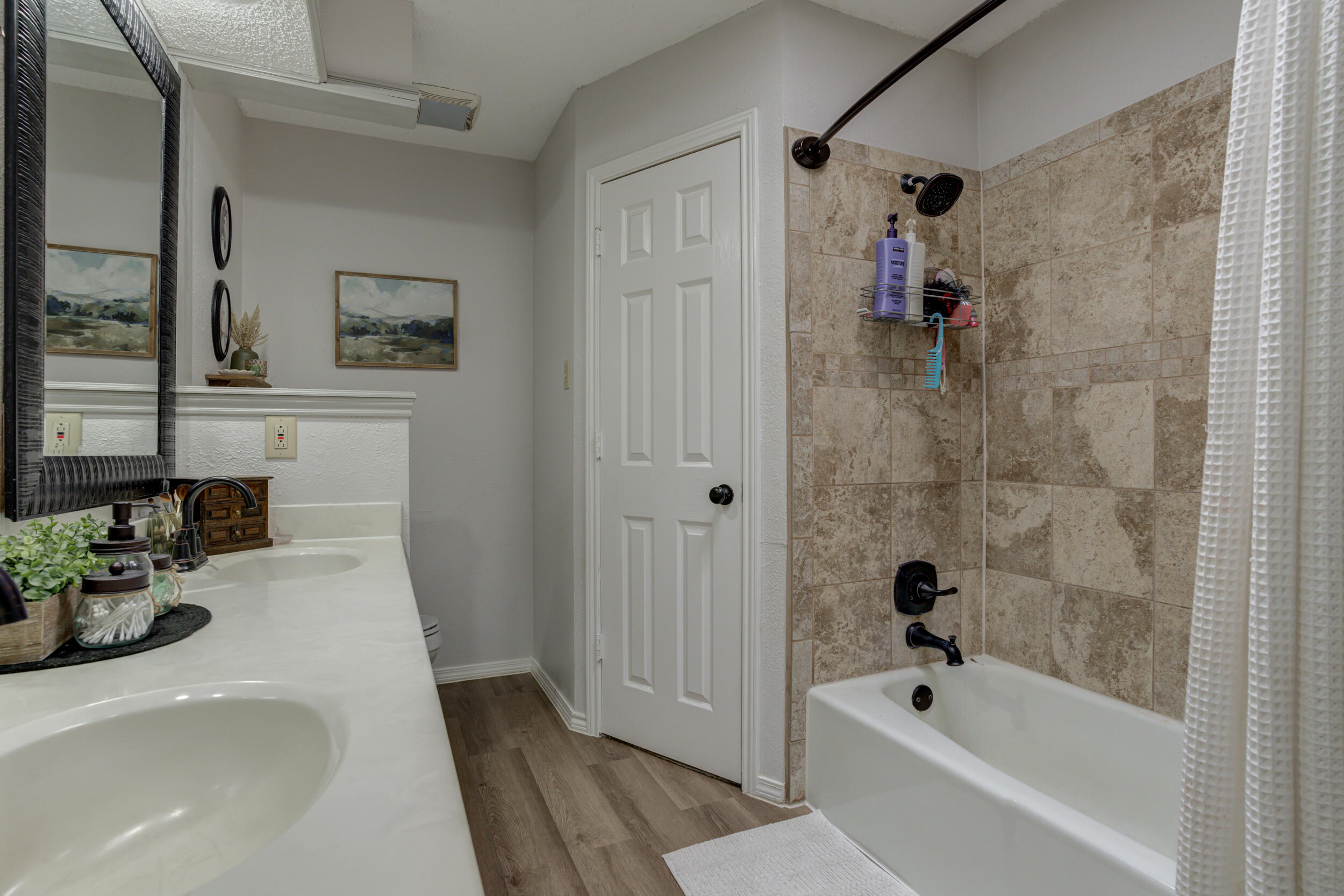 3712 103rd Street Lubbock, TX 79423 - Photo 32 of 43 a bathroom with a tub shower sink and vanity
