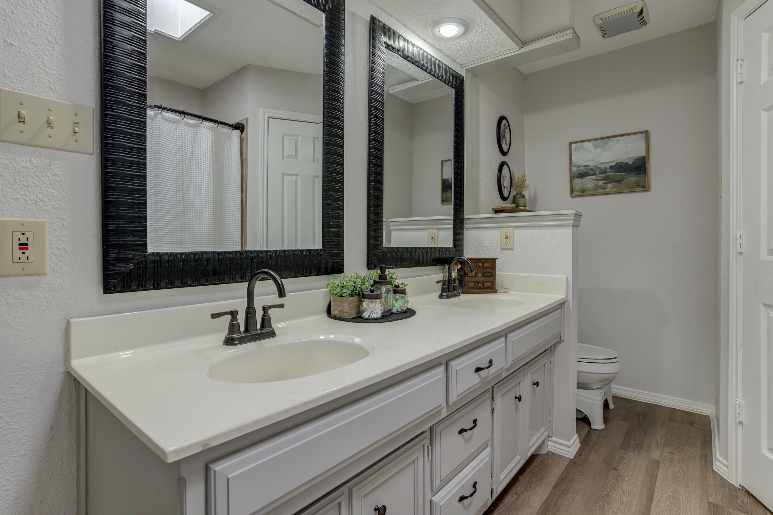 3712 103rd Street Lubbock, TX 79423 - Photo 33 of 43 a bathroom with double sink and a mirror