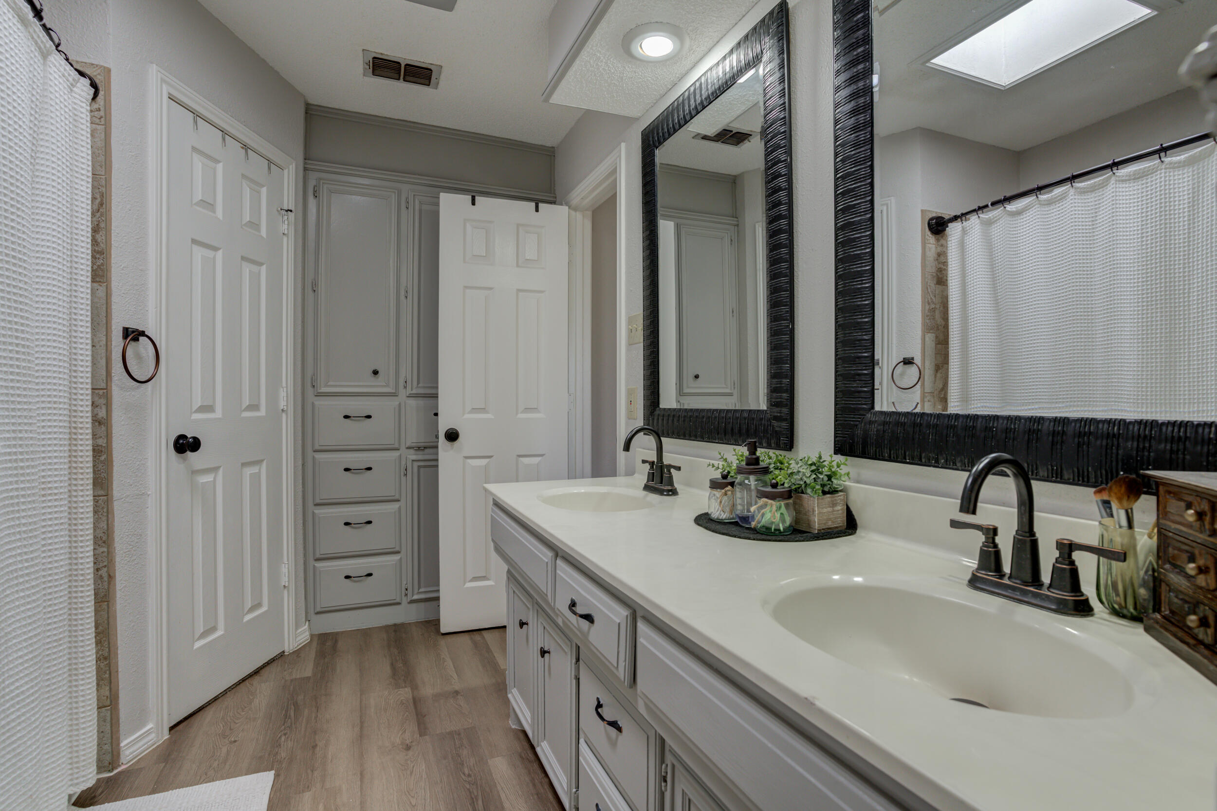 3712 103rd Street Lubbock, TX 79423 - Photo 34 of 43 a bathroom with double vanity sink and mirror