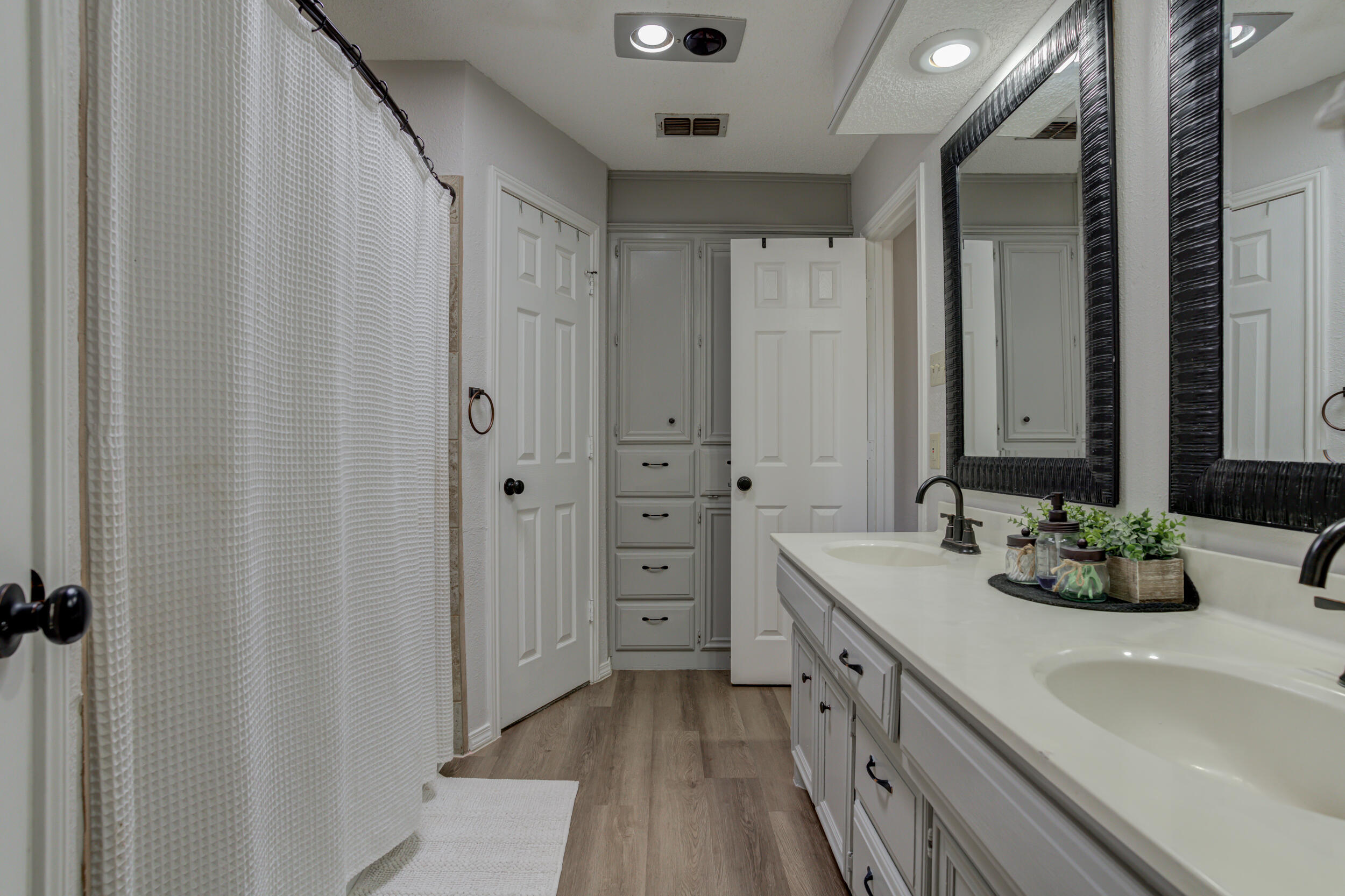 3712 103rd Street Lubbock, TX 79423 - Photo 35 of 43 a bathroom with a double vanity sink and mirror