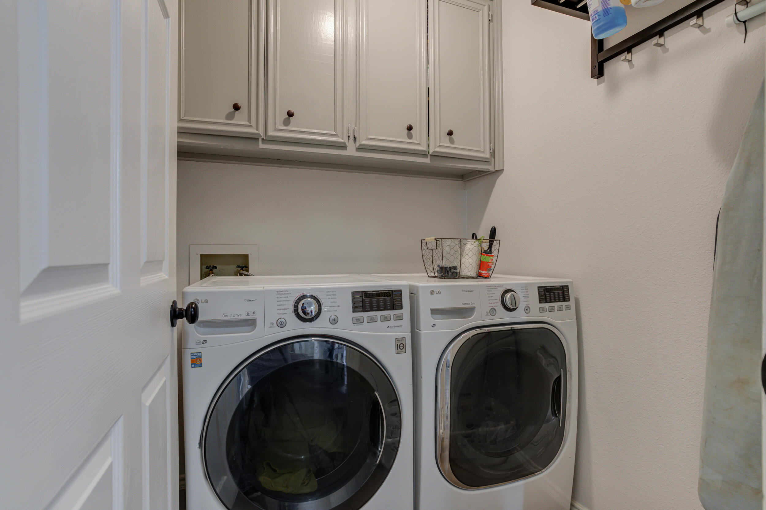 3712 103rd Street Lubbock, TX 79423 - Photo 37 of 43 a view of washer and dryer with kitchen in the background