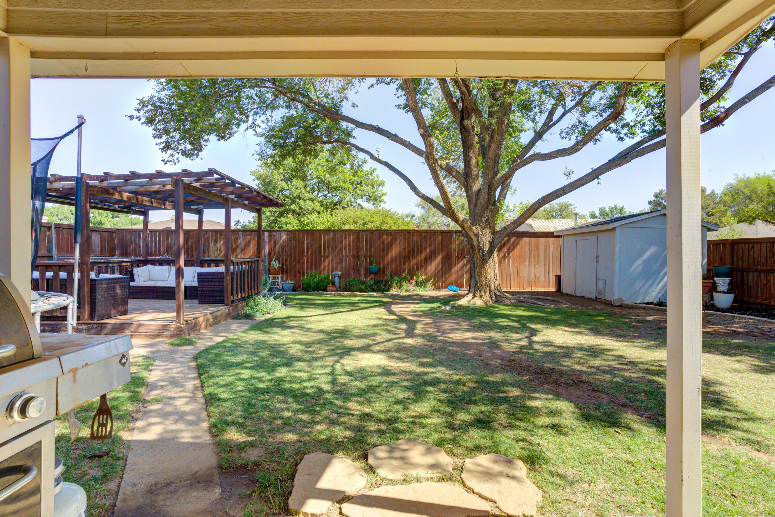 3712 103rd Street Lubbock, TX 79423 - Photo 38 of 43 a backyard of a house with table and chairs