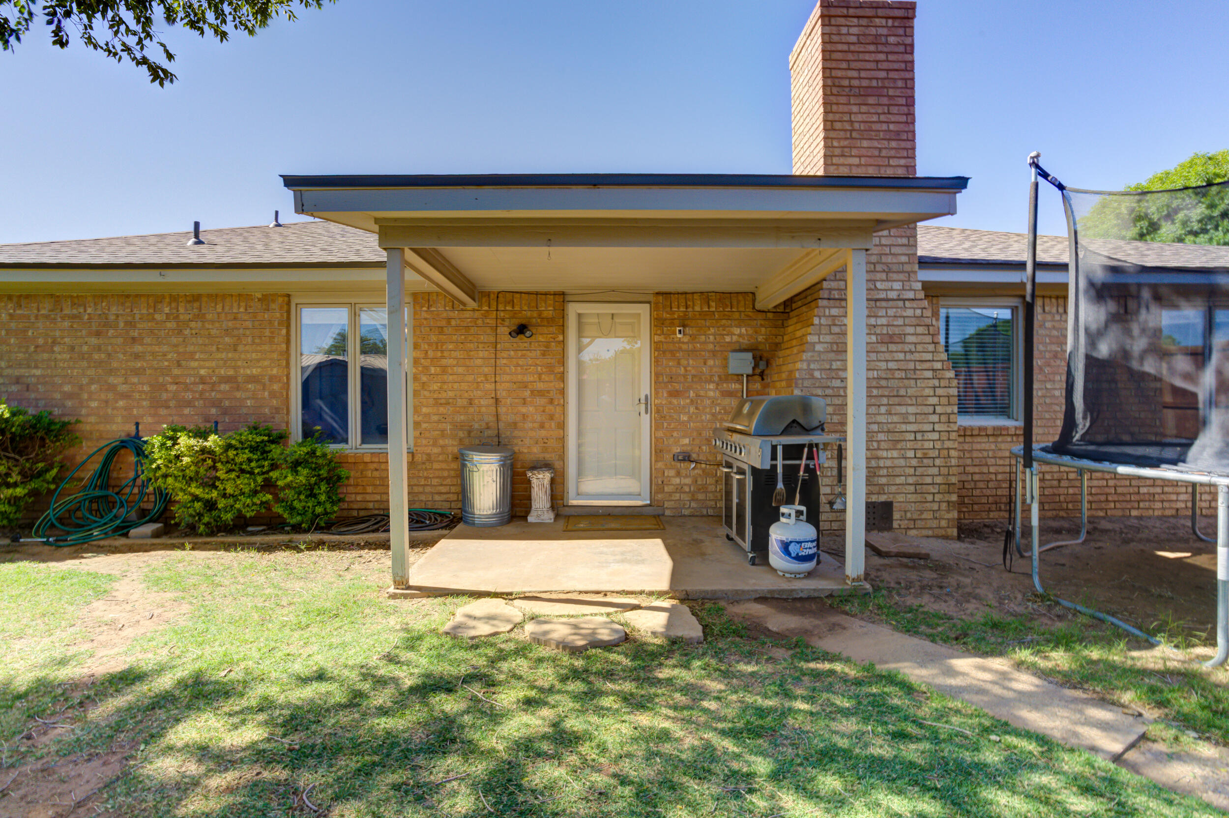 3712 103rd Street Lubbock, TX 79423 - Photo 39 of 43 a view of a house with potted plants and a yard