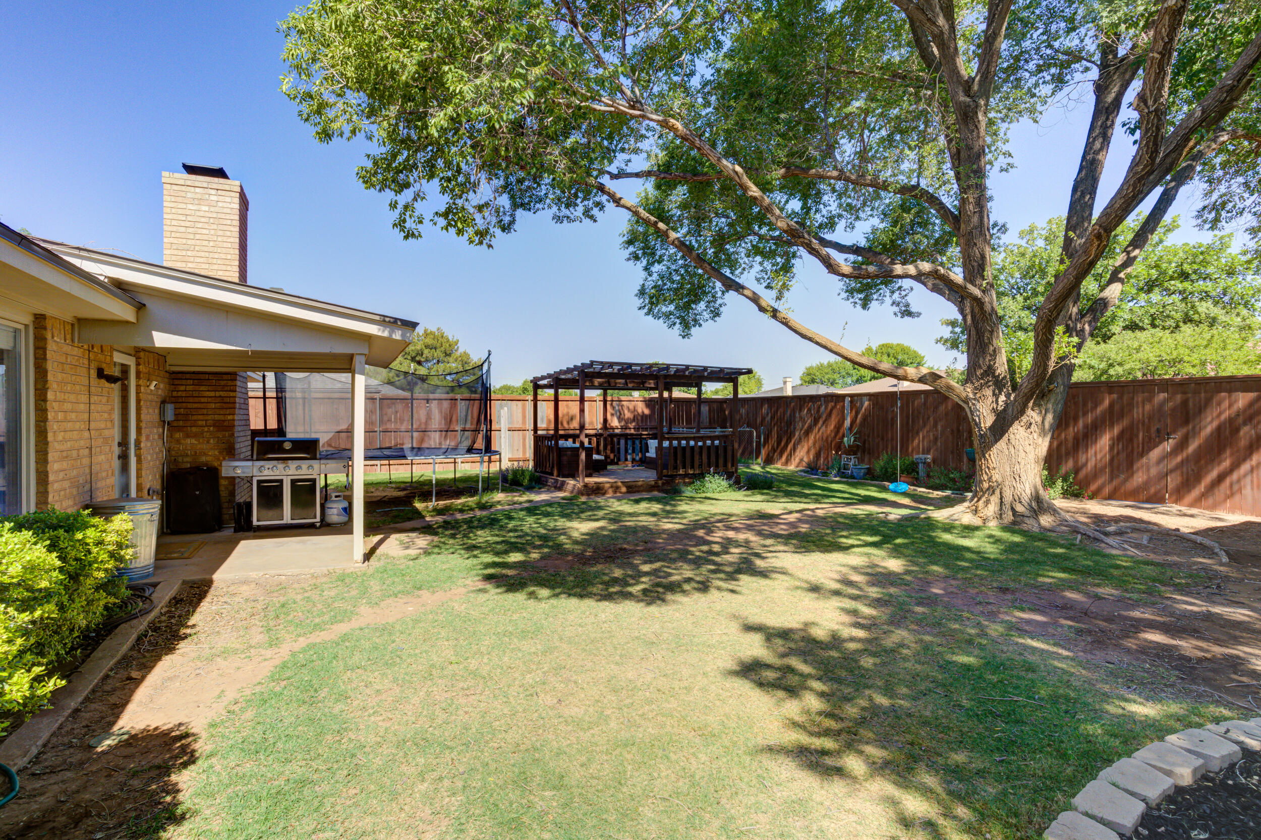 3712 103rd Street Lubbock, TX 79423 - Photo 43 of 43 a view of a house with a yard tree and sitting area