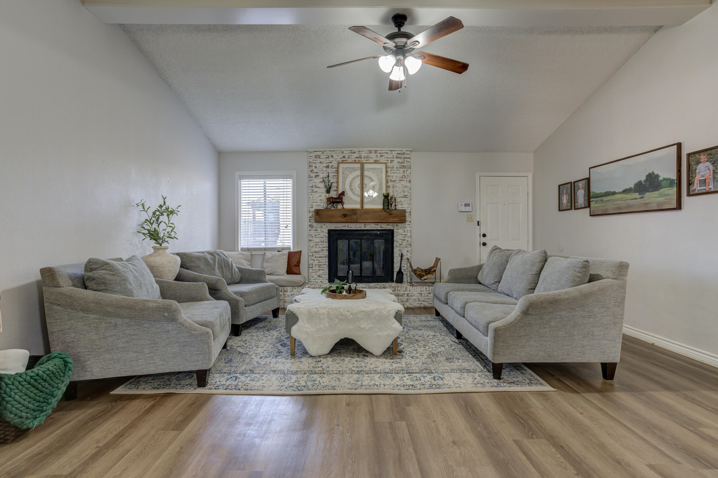 3712 103rd Street Lubbock, TX 79423 - Photo 5 of 43 a living room with furniture a fireplace and wooden floor