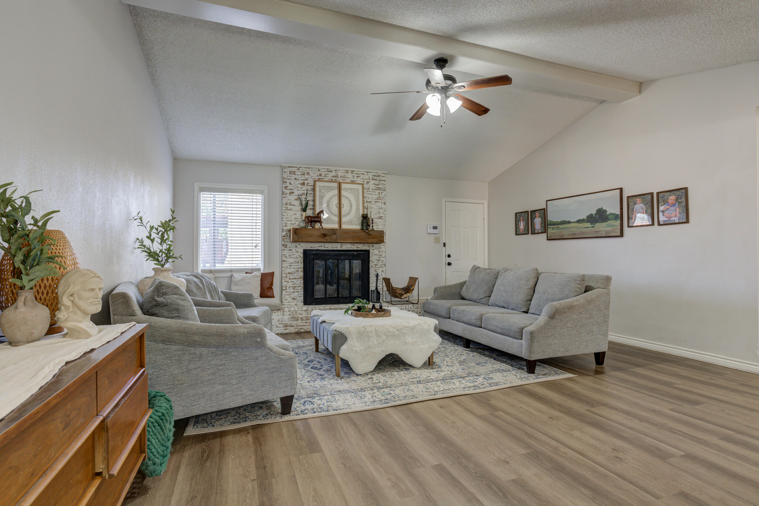 3712 103rd Street Lubbock, TX 79423 - Photo 6 of 43 a living room with furniture and a fireplace