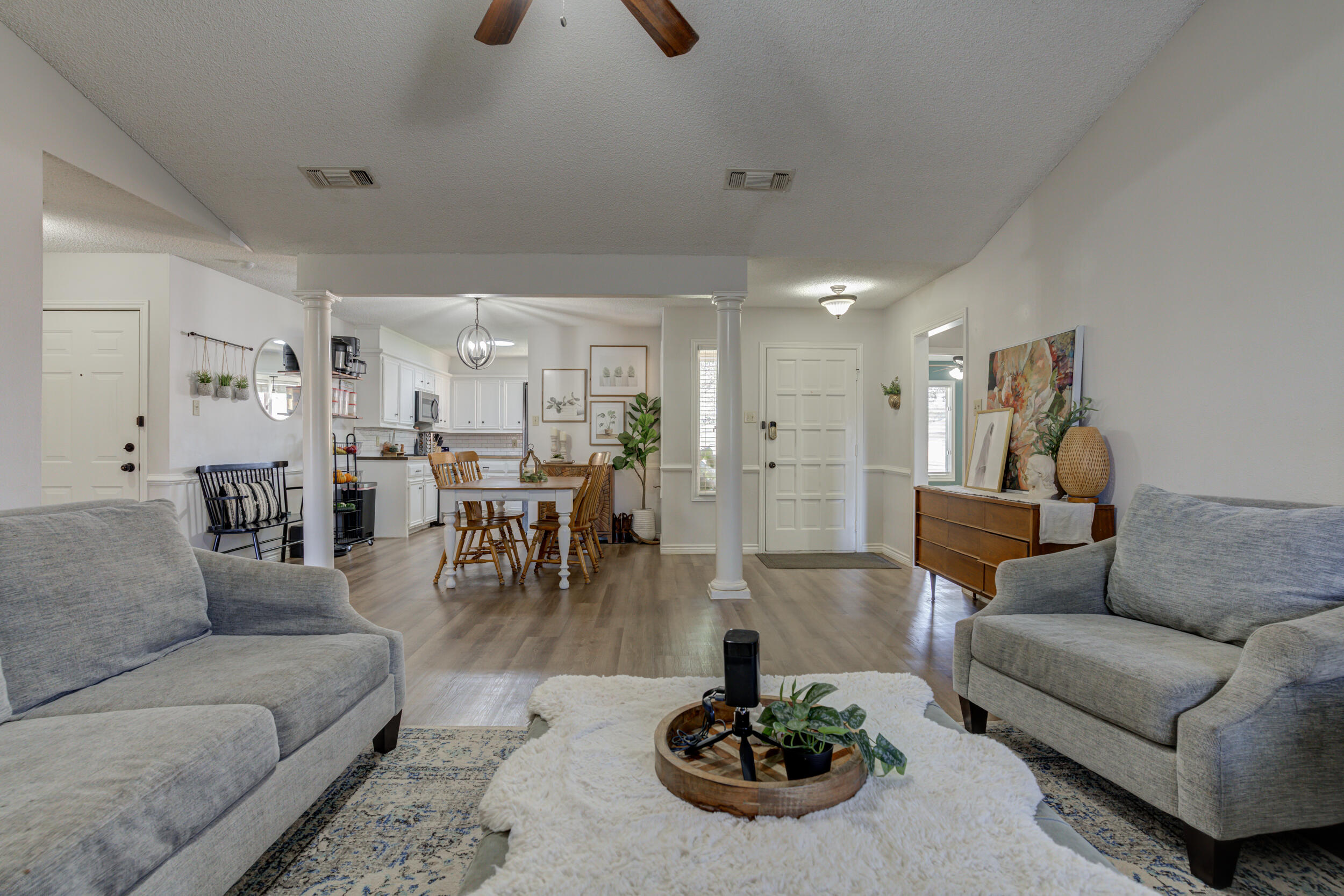 3712 103rd Street Lubbock, TX 79423 - Photo 8 of 43 a living room with furniture and a dining table with kitchen view