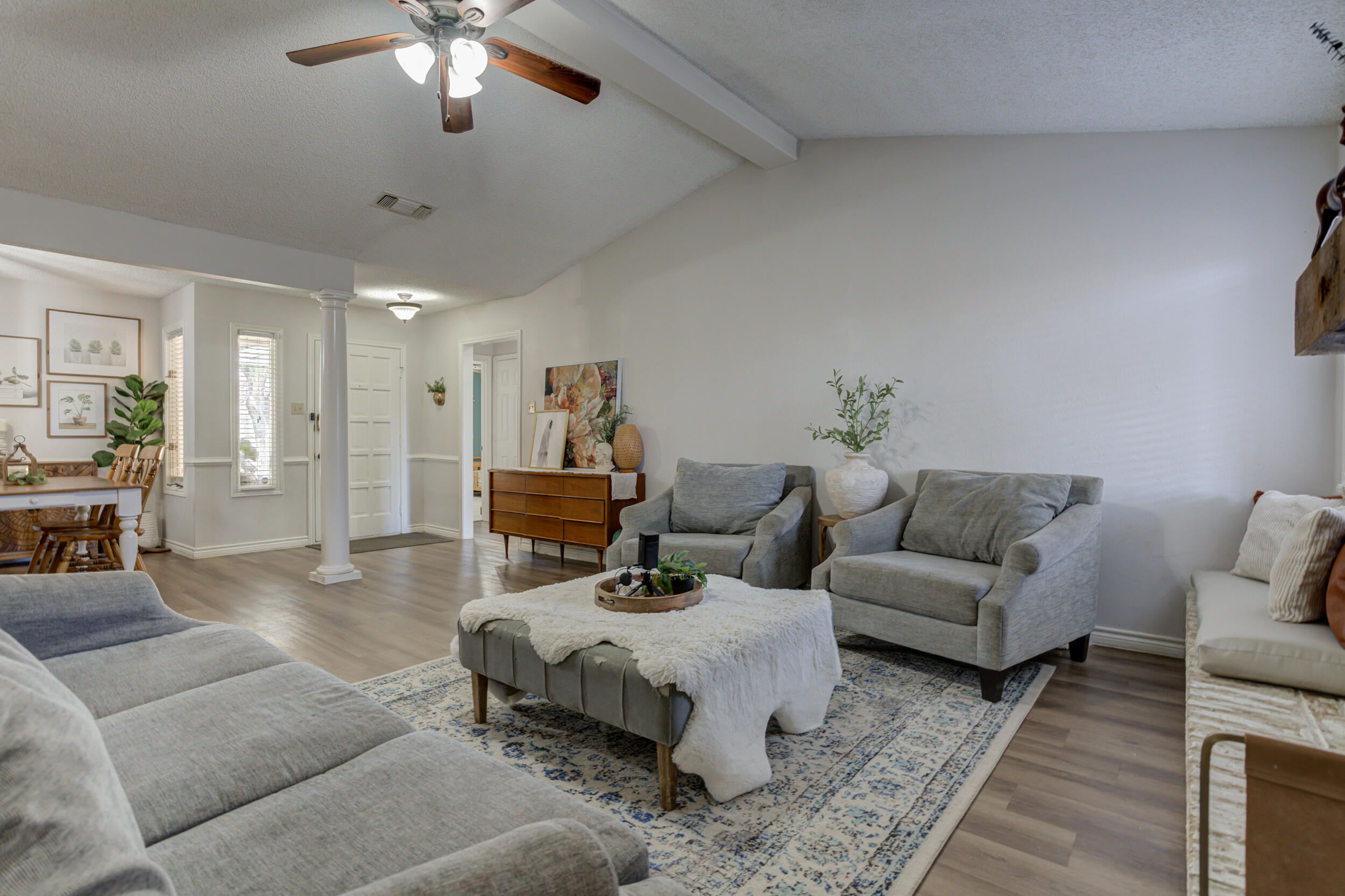 3712 103rd Street Lubbock, TX 79423 - Photo 9 of 43 a living room with furniture and a chandelier