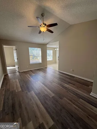 a view of an empty room and wooden floor