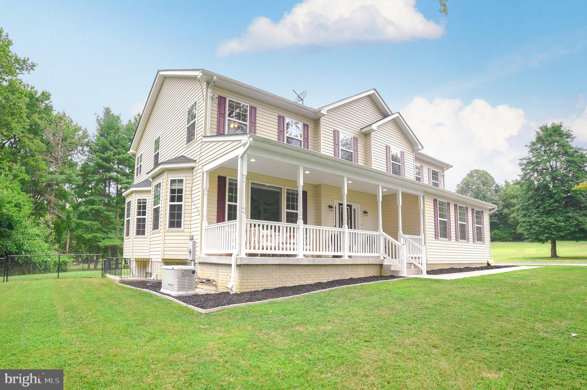 2160 Lowery Road Huntingtown, MD 20639 - Photo 2 of 53 a front view of a house with a yard table and trees