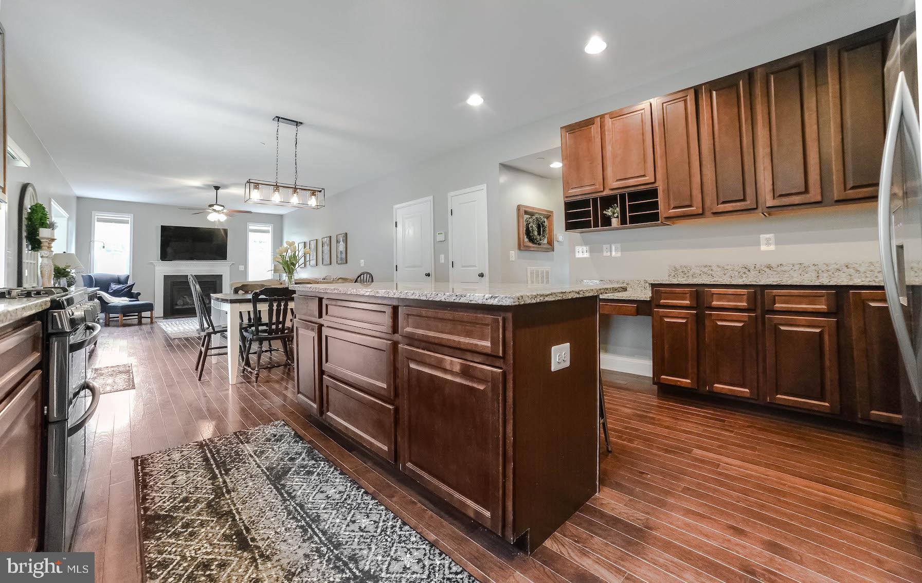 2160 Lowery Road Huntingtown, MD 20639 - Photo 11 of 53 a kitchen with stainless steel appliances granite countertop wooden cabinets a sink and a stove
