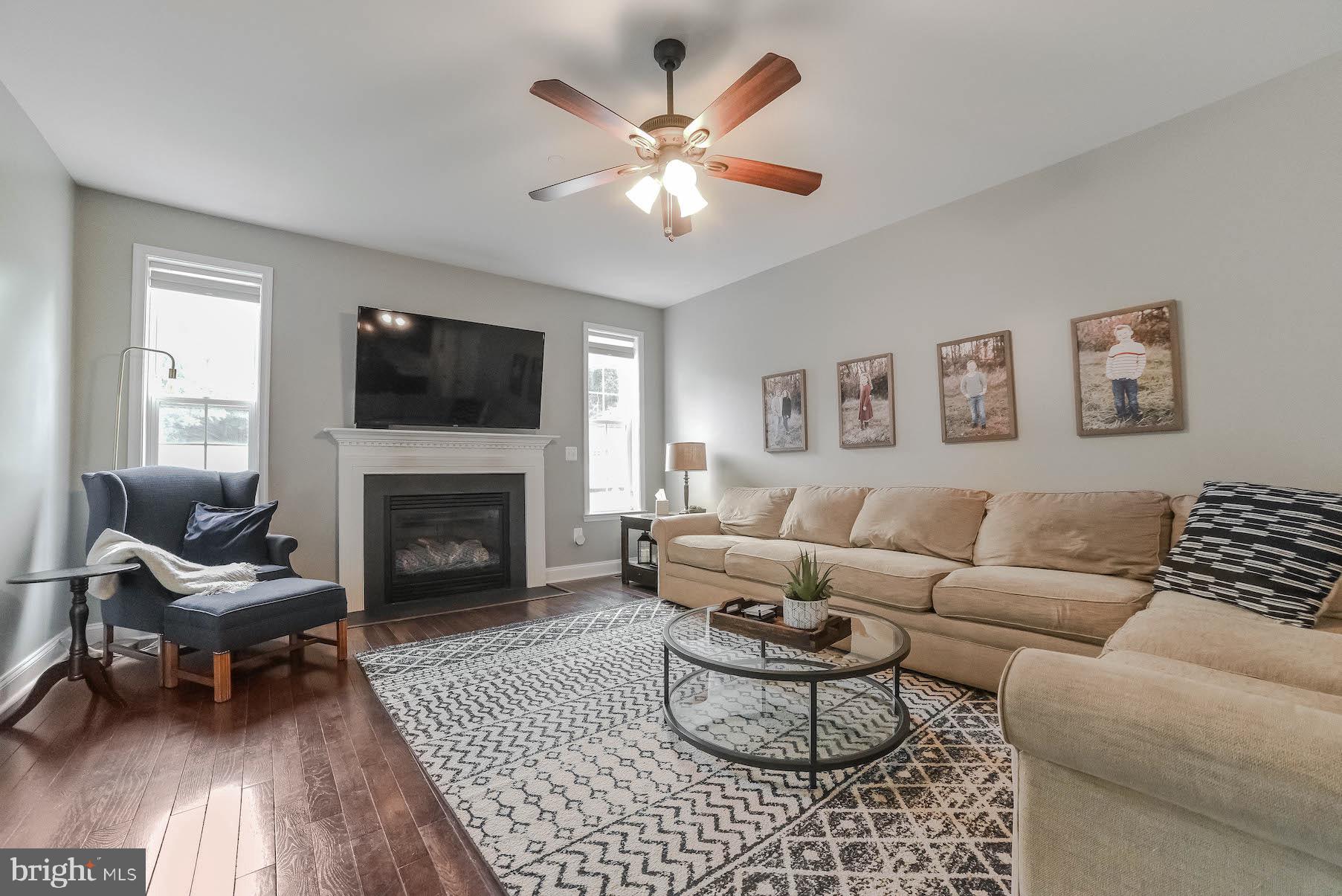 2160 Lowery Road Huntingtown, MD 20639 - Photo 18 of 53 a living room with furniture a fireplace and a flat screen tv