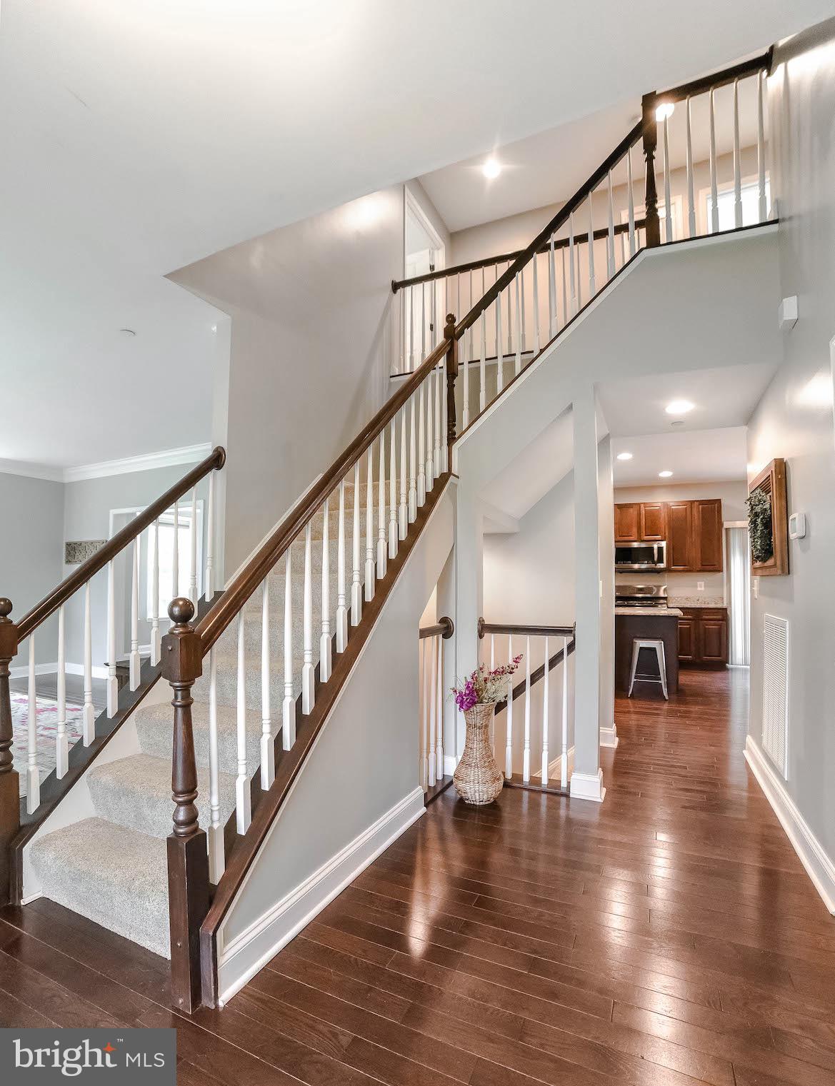 2160 Lowery Road Huntingtown, MD 20639 - Photo 3 of 53 a view of staircase and dining room with wooden floor