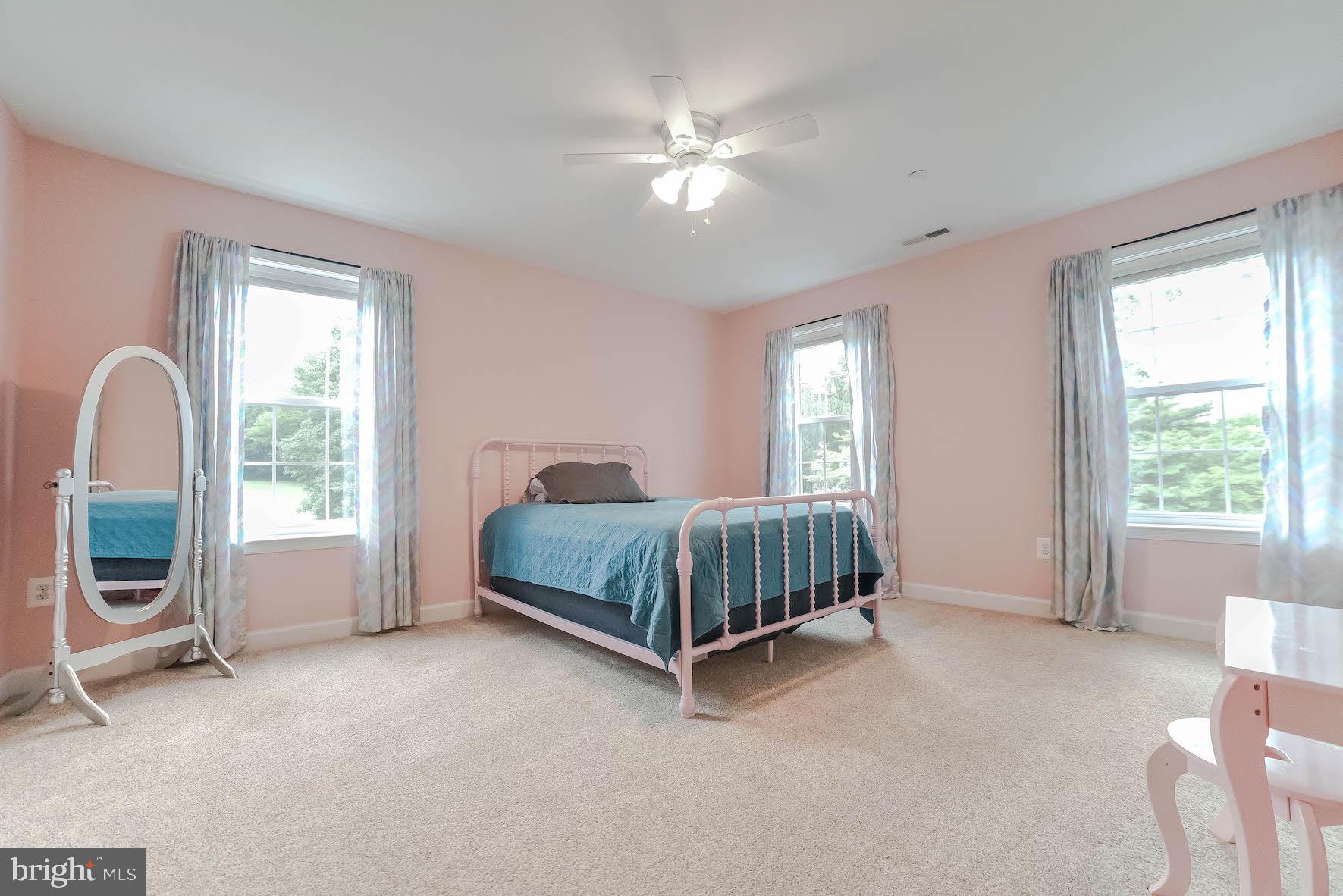2160 Lowery Road Huntingtown, MD 20639 - Photo 27 of 53 a bedroom with a bed a table and a large window