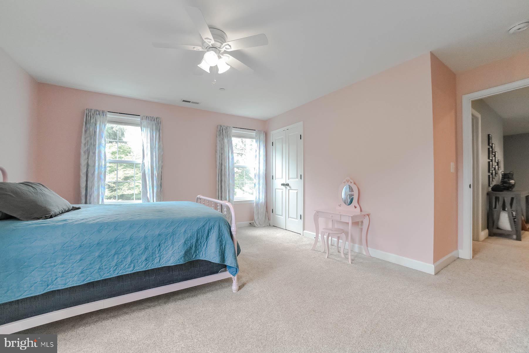 2160 Lowery Road Huntingtown, MD 20639 - Photo 28 of 53 a bedroom with a bed and a chandelier