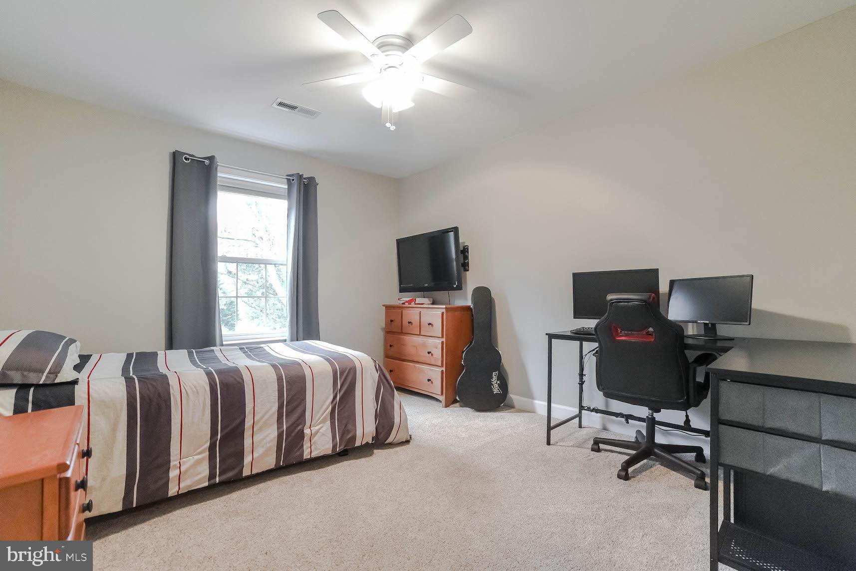 2160 Lowery Road Huntingtown, MD 20639 - Photo 29 of 53 a bedroom with a bed and a chair