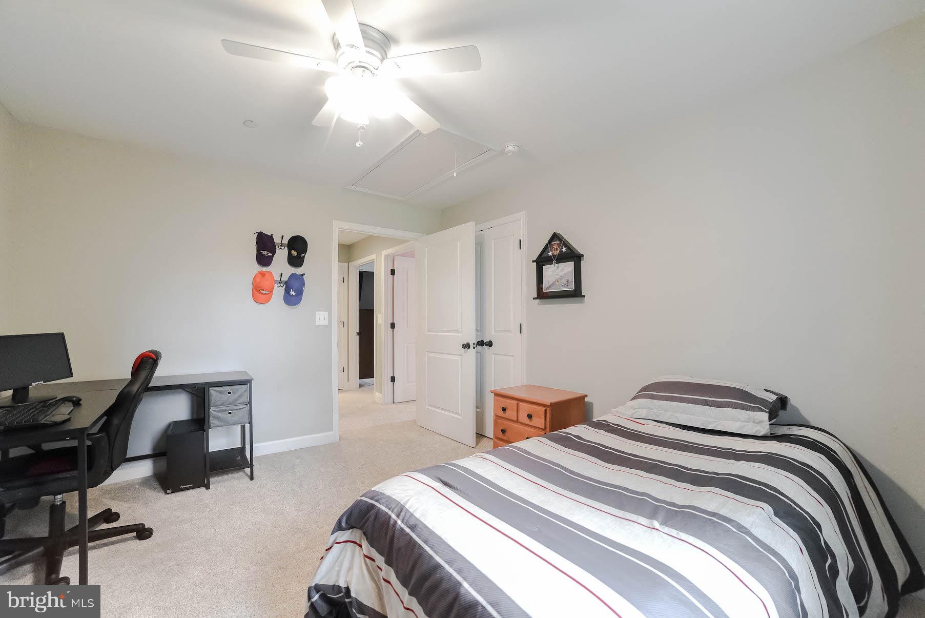 2160 Lowery Road Huntingtown, MD 20639 - Photo 30 of 53 a bedroom with a bed and a chandelier