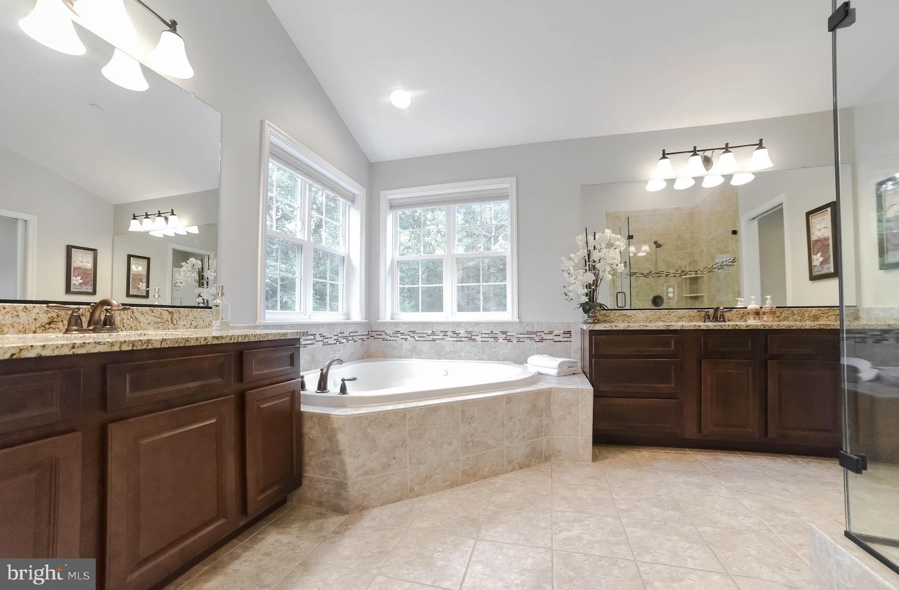 2160 Lowery Road Huntingtown, MD 20639 - Photo 35 of 53 a large bathroom with a tub a sink and mirror