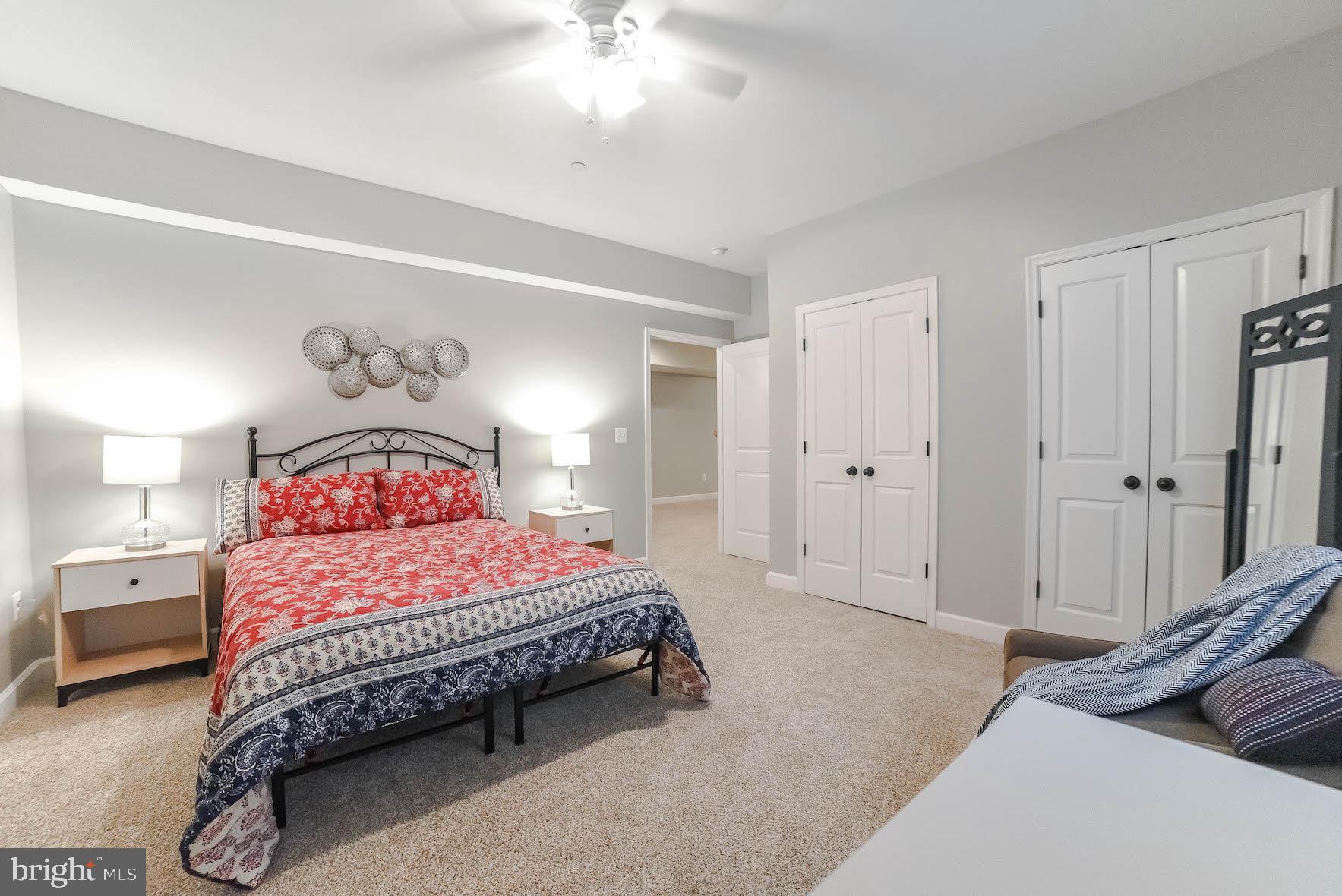 2160 Lowery Road Huntingtown, MD 20639 - Photo 45 of 53 a bedroom with a bed and a chandelier