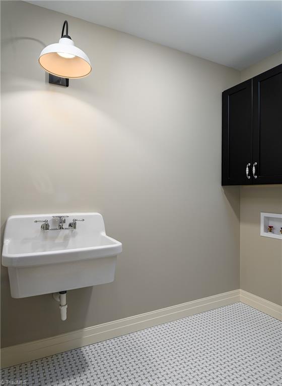 8268 Ballard Road Colfax, NC 27235 - Photo 28 of 50 Conveniently located just outside the primary is a laundry room with a wide basin farmhouse sink.