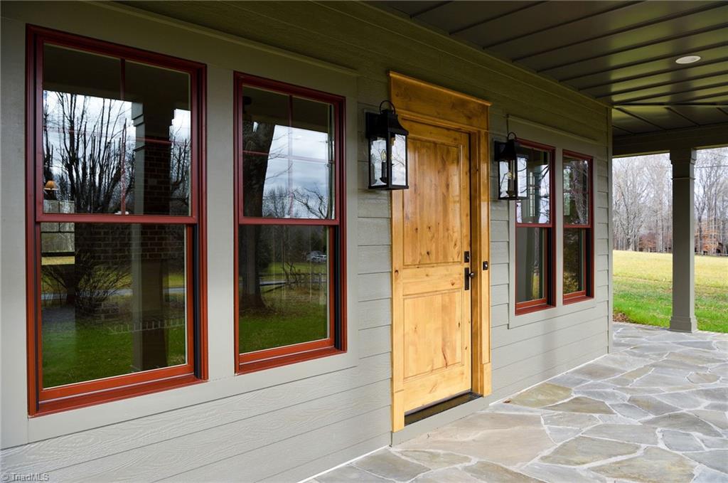 8268 Ballard Road Colfax, NC 27235 - Photo 3 of 50 Notice the eye for detail in the Alder wood door, flagstone porch, every detail has been carefully crafted with you in mind.