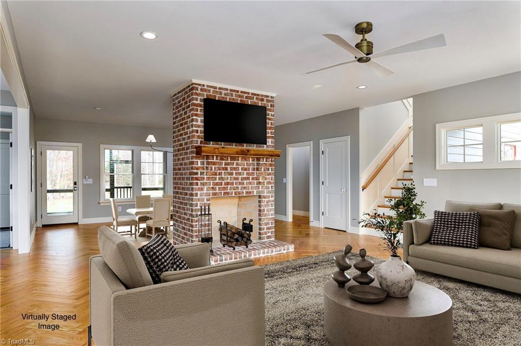 8268 Ballard Road Colfax, NC 27235 - Photo 5 of 50 Upon entry, the herringbone floors & masonry fireplace hint at the beauty and warmth of the indoor living space.