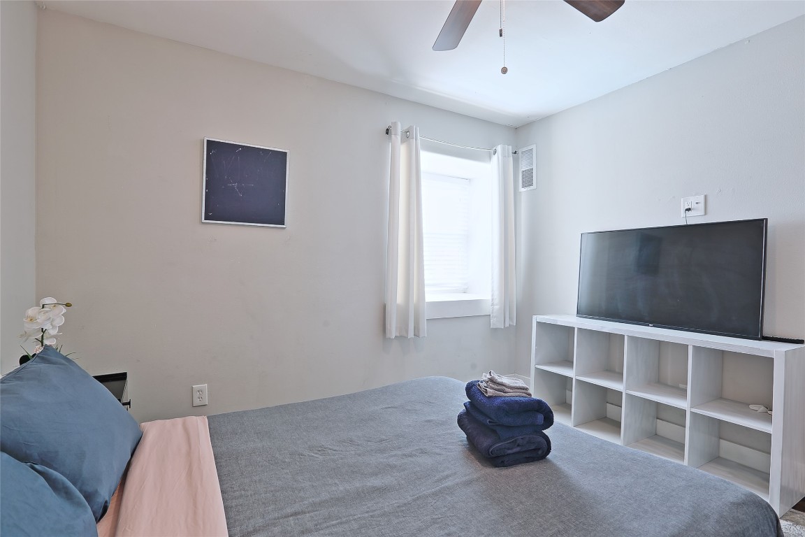 4804 West Wind Trail, Unit 102 Austin, TX 78745 - Photo 14 of 24 a bedroom with a bed and a window