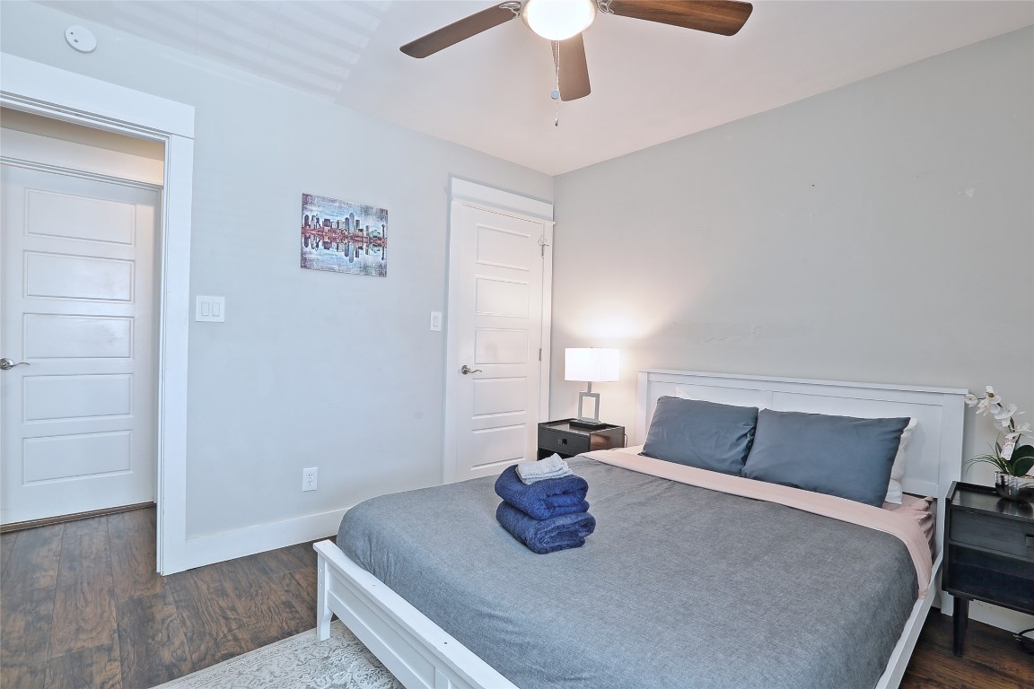 4804 West Wind Trail, Unit 102 Austin, TX 78745 - Photo 15 of 24 a bedroom with a bed and wooden floor