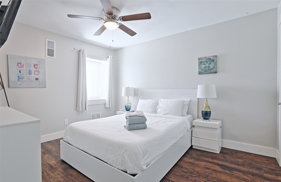 4804 West Wind Trail, Unit 102 Austin, TX 78745 - Photo 16 of 24 a bedroom with a bed and a chandelier