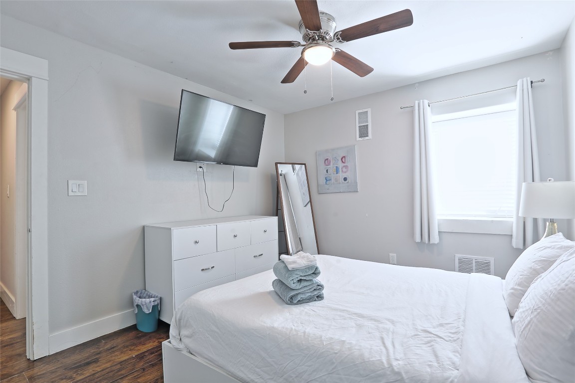 4804 West Wind Trail, Unit 102 Austin, TX 78745 - Photo 17 of 24 a bedroom with a bed and a flat screen tv