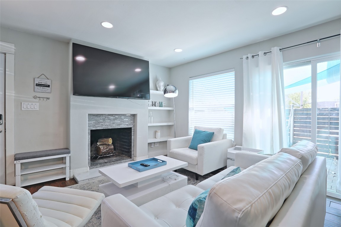 4804 West Wind Trail, Unit 102 Austin, TX 78745 - Photo 2 of 24 a living room with furniture and a fireplace
