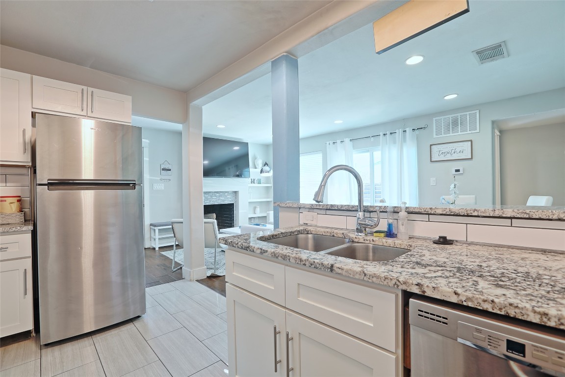 4804 West Wind Trail, Unit 102 Austin, TX 78745 - Photo 8 of 24 a kitchen with sink refrigerator and cabinets