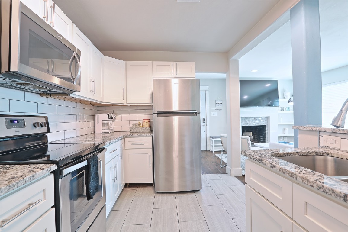 4804 West Wind Trail, Unit 102 Austin, TX 78745 - Photo 10 of 24 a kitchen with a refrigerator stove and sink