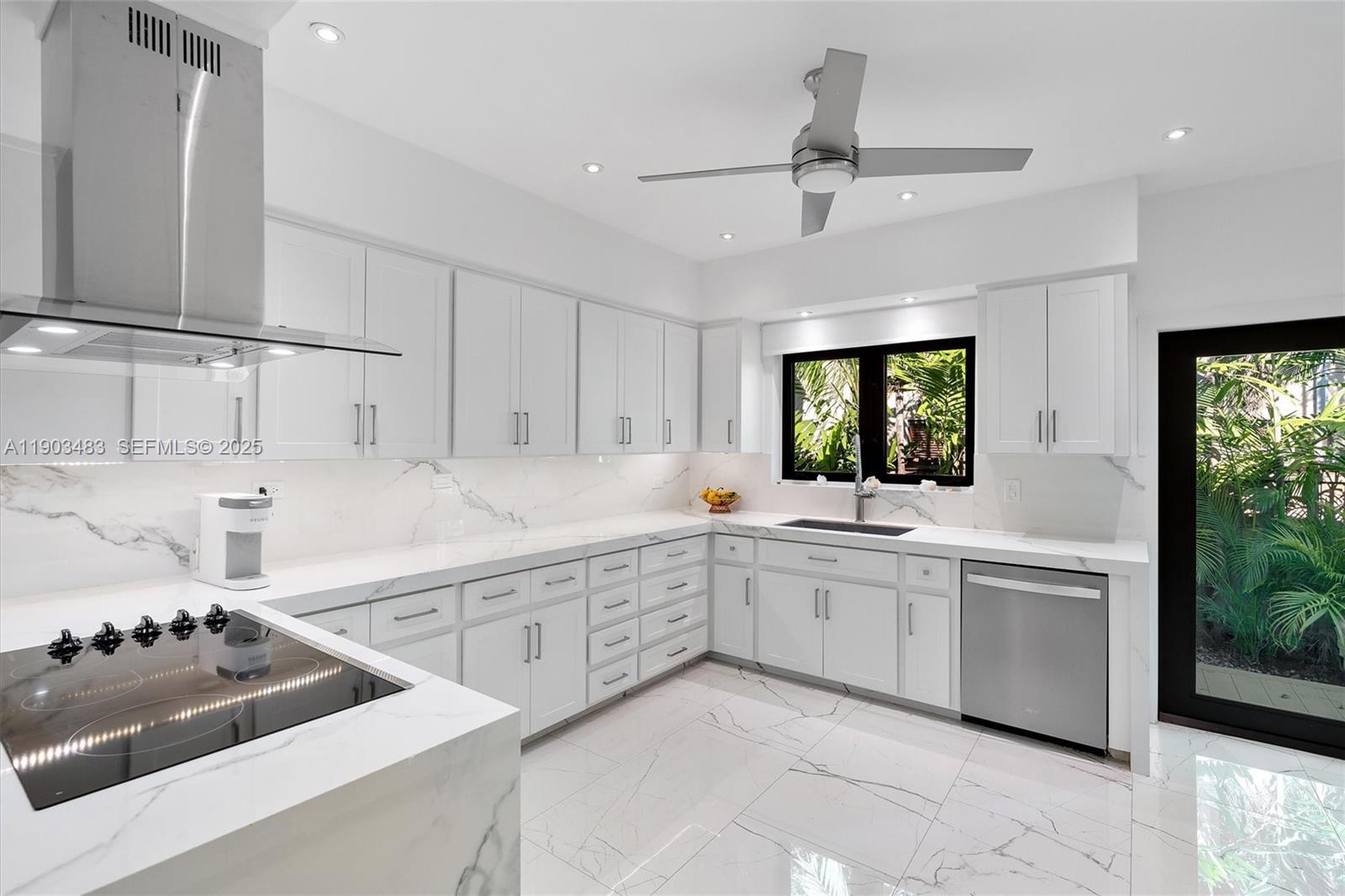 641 Island Road Miami, FL 33137 - Photo 14 of 16 a kitchen with white cabinets and appliances