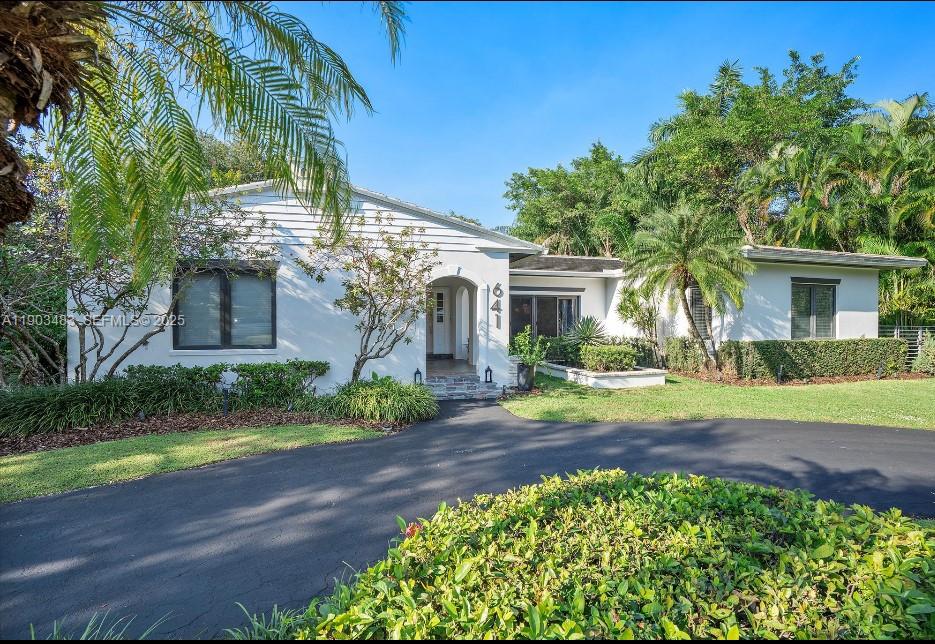 641 Island Road Miami, FL 33137 - Photo 16 of 16 a front view of a house with a garden