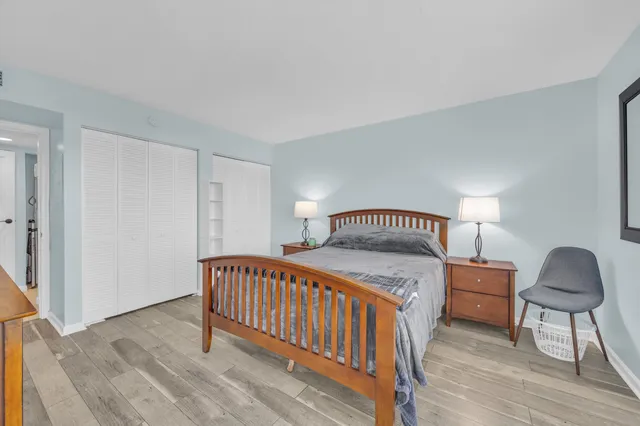 a bedroom with a bed and a lamp