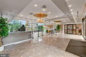 1836 Metzerott Road, Unit 901 Hyattsville, MD 20783 - Photo 2 of 20 a view of a hall with floor to ceiling window and potted plants