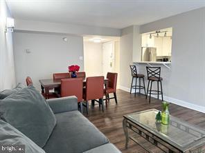 1836 Metzerott Road, Unit 901 Hyattsville, MD 20783 - Photo 5 of 20 a living room with furniture and a wooden floor