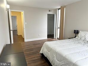 1836 Metzerott Road, Unit 901 Hyattsville, MD 20783 - Photo 9 of 20 a bedroom with a bed and wooden floor