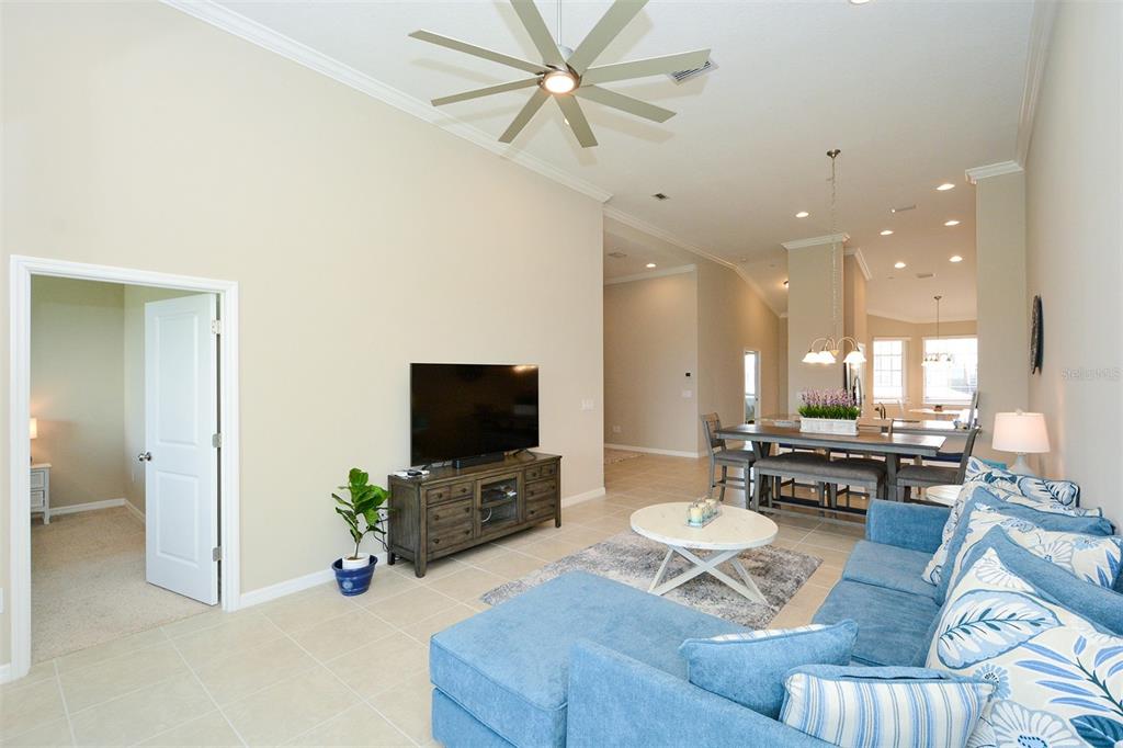 13737 Messina Loop, Unit 202 Lakewood Ranch, FL 34211 - Photo 12 of 49 a living room with furniture and a flat screen tv